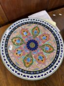 Large earthenware charger decorated in the Art Nouveau style with a central brightly coloured floral