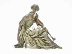 Large bronze lady in repose probably from a clock garniture, 25cm long