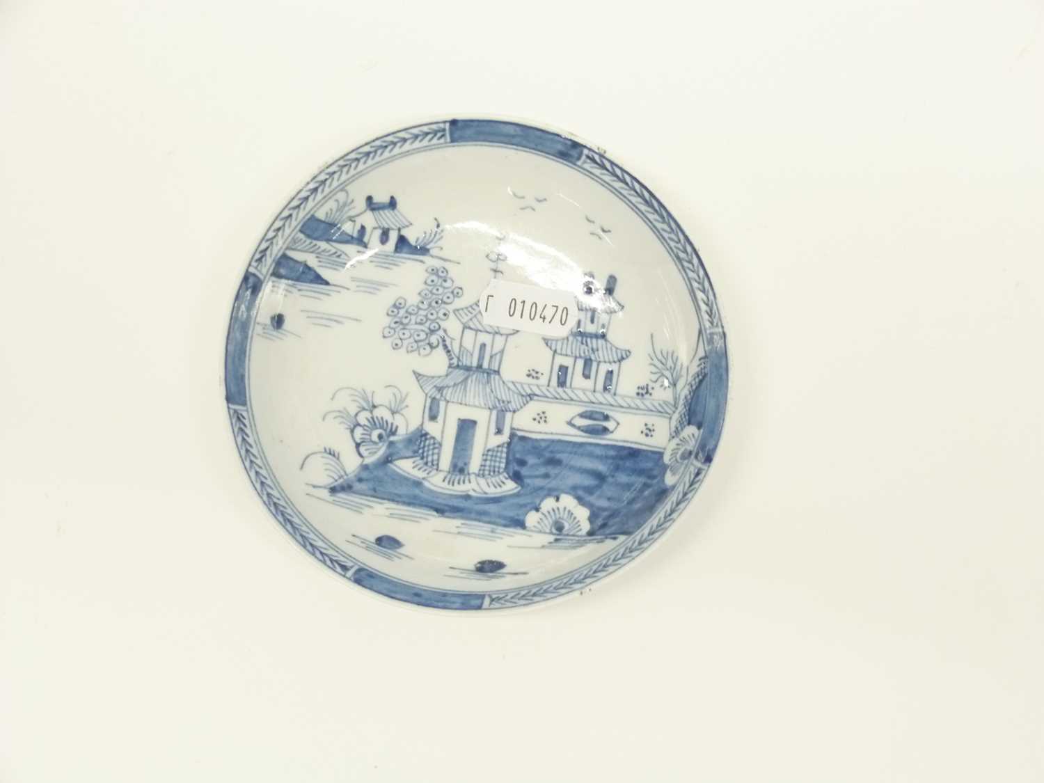 Three Lowestoft blue and white saucers, two with pagoda river scenes, one with a floral and fence - Image 2 of 4