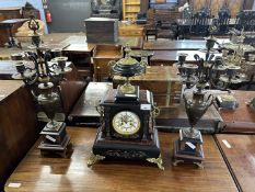 Late 19th Century French black slate and marble clock garniture, the central clock with urn formed