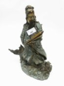 A large bronzed model of a Chinese Deity holding a scroll on scroll base, 40cm high