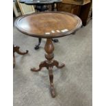 Reproduction mahogany circular top wine table on a turned column with tripod base, 77cm high