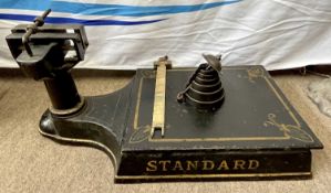 A set of 19th Century Japanned or toleware standard scales with weights up to 23.5 stone