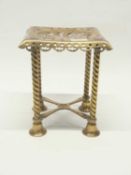 A brass column raised on four column legs with frilled and pierced design to top, late 19th Century,
