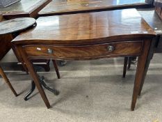 A small 19th Century mahogany serpentine front single drawer side table with brass ringlet