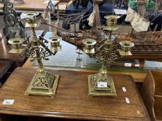 A pair of late 19th Century asthetic style brass three light candelabra with pierced decoration