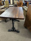 20th Century pub table with rectangular stained pine top over a cast iron base, 107cm wide