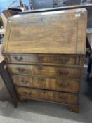 A small Georgian mahogany bureau of typical form, the full front opening to an interior with small