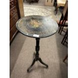 A small ebonised, gilt and floral painted pedestal table on tripod base, 77cm high