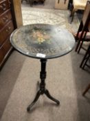 A small ebonised, gilt and floral painted pedestal table on tripod base, 77cm high