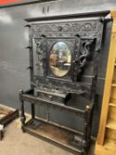 Late Victorian gothic carved hall stand with central oval mirror and glove drawer, extensively