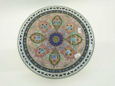 Large earthenware charger decorated in the Art Nouveau style with a central brightly coloured floral