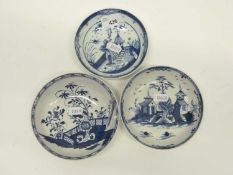 A group of three Lowestoft porcelain saucers with various blue and white designs