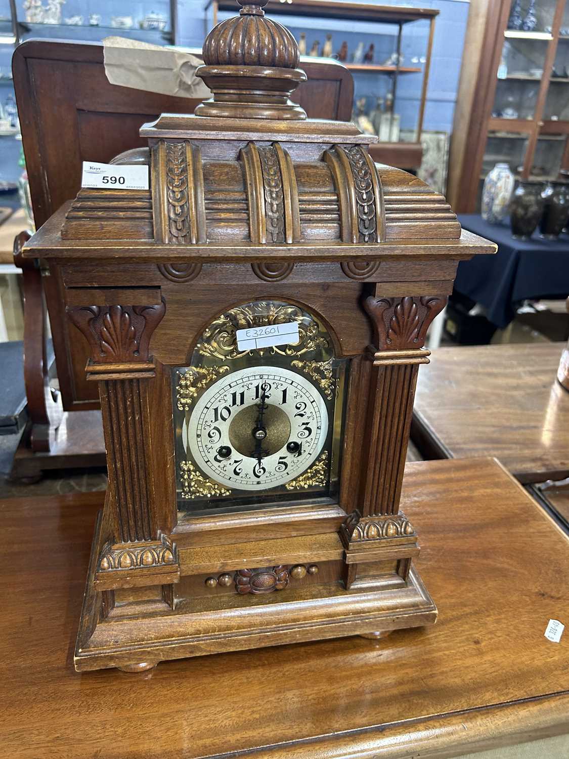 A late 19th Century mantel clock set in an architectural carved wooden case, fitted with a brass - Image 2 of 2