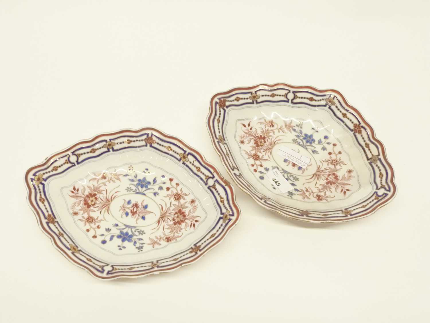 Two late 18th Century Derby porcelain dishes of oval shape with shaped rims, decorated in iron red