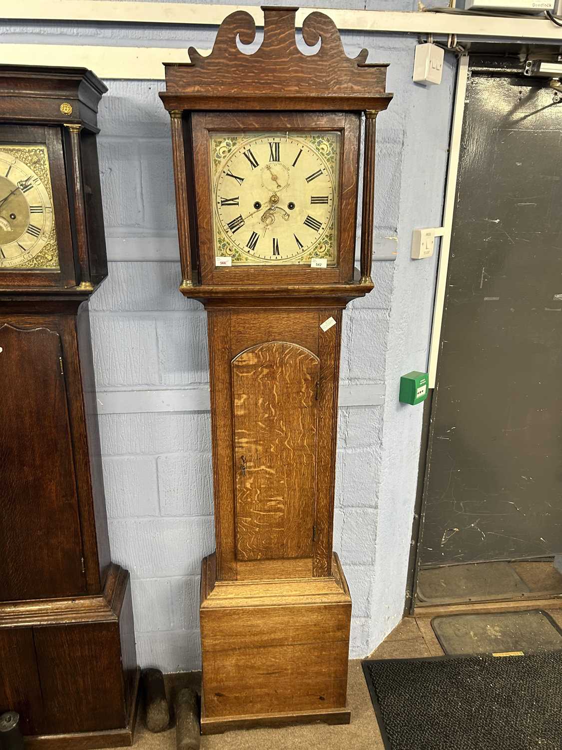 Georgian long case clock with unsigned floral painted dial, with an eight day movement, set in a oak