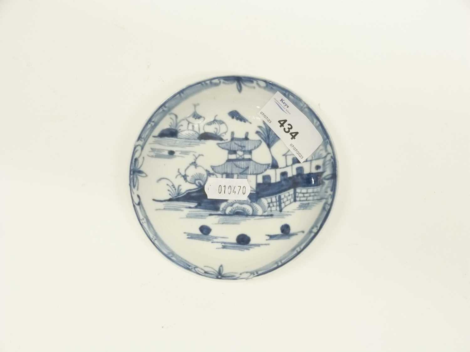 Three Lowestoft blue and white saucers, two with pagoda river scenes, one with a floral and fence - Image 4 of 4