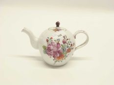 A 18th Century continental porcelain teapot and cover of reeded form decorated with flowers in