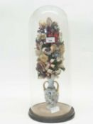Large clear glass dome and base containing a vase of fabric flowers, 53cm high