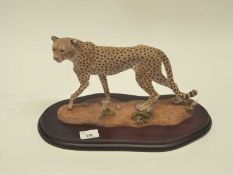 A large model of a cheetah entitled "Agile Spirit" made by Country Artists on a shaped wooden