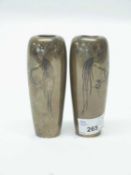 A pair of cylindrical Japanese metal vases with inlaid metal decoration in copper of birds on