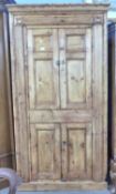 A 19th Century waxed pine four door corner cupboard, 195cm high, 104cm wide