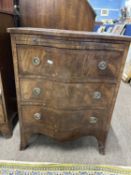 Reproduction mahogany veneered serpentine front three drawer chest of small proportions fitted