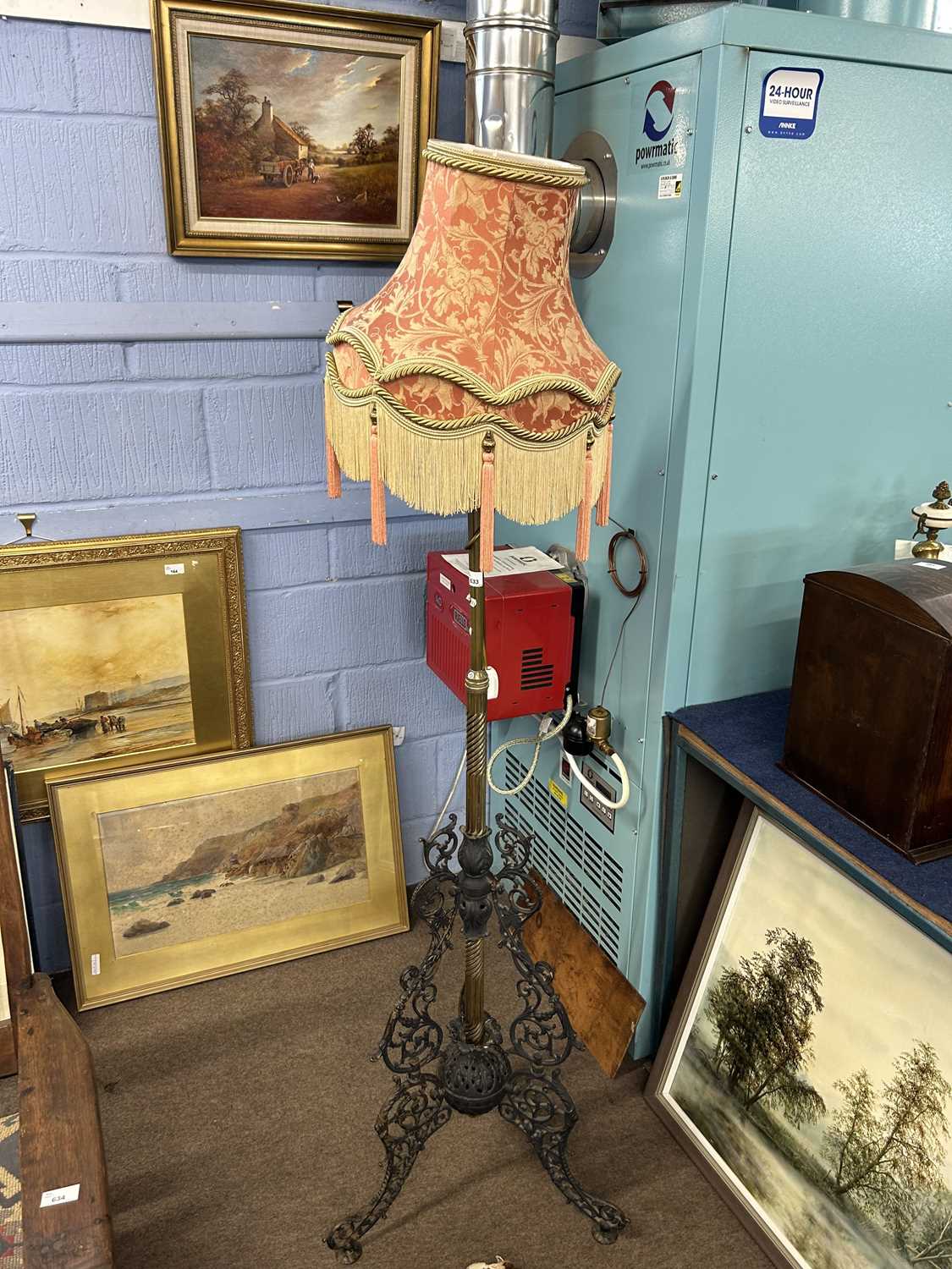 Late 19th Century iron and brass standard lamp with frilled shade, approx 170cm high