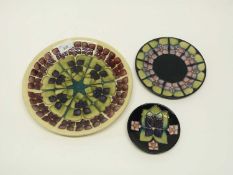 Group of three Moorcroft plates of various sizes with tube lined designs, largest 26cm diameter