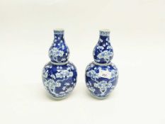 Pair of 19th Century Chinese porcelain vases of gourd shape, the blue ground decorated with