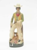 A regal china spirit flask modelled as a cowboy, 36cm high