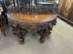 Large Burmese hardwood demi-lune hall table with pierced back and leopard head legs, approx 140cm