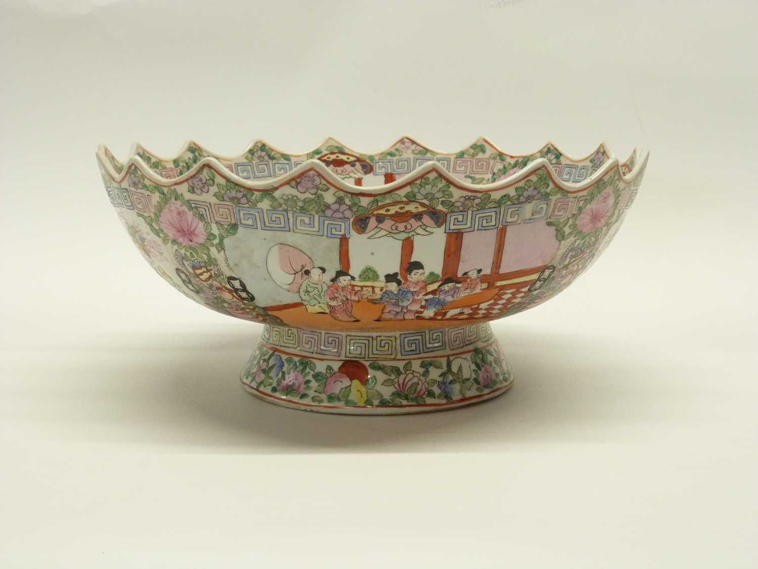 A large 20th Century Chinese porcelain punch bowl with shaped rim decorated with panels of Chinese