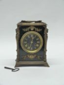 A 19th Century brass mantel clock, black ebonised wood with gilt brass decoration, 23cm high (with