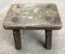 A primitive 19th Century rustic oak milking stool