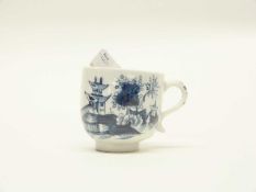 A coffee cup with a pagoda and a river scene