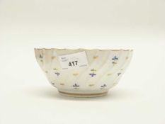 A Flight Worcester porcelain bowl of wrythen form decorated with sprigs of flowers in polychrome and
