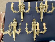 An impressive set of four early 20th Century Louise VXI-style gilt bronze wall lights, each light