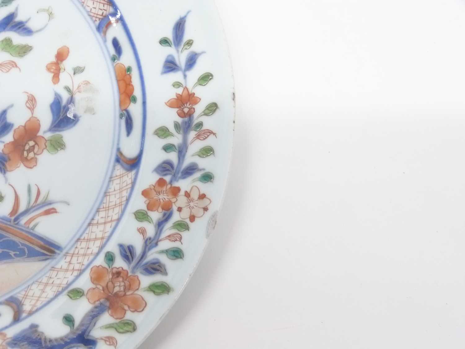 A 18th Century Chinese porcelain plate decorated in Imari style with blue and white trees and - Image 2 of 3