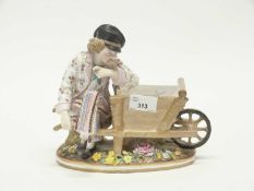 A 19th Century flower spill holder vase modelled as a wheelbarrow with gentleman beside on shaped