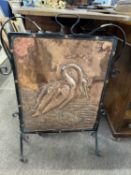 Arts & Crafts style copper and iron mounted fire screen decorated with a cormorant, 71cm high