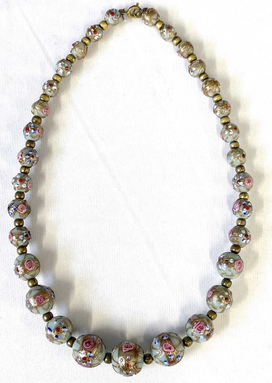 A 1950's graduated Murano glass bead necklace with hand painted floral patterns on aqua ground
