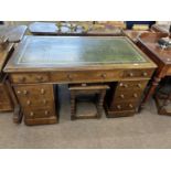 Victorian mahogany twin pedestal desk with nine drawers and a green inset leather writing surface,