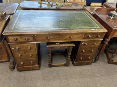 Victorian mahogany twin pedestal desk with nine drawers and a green inset leather writing surface,