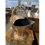 A late 19th Century copper coal scuttle with accompanying shovel, 34cm high