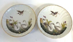 Two continental porcelain small dishes decorated in relief with swans amongst bullrushes, 15cm