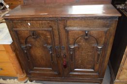 An unusual 19th Century oak side cabinet with two panelled doors opening to an interior with