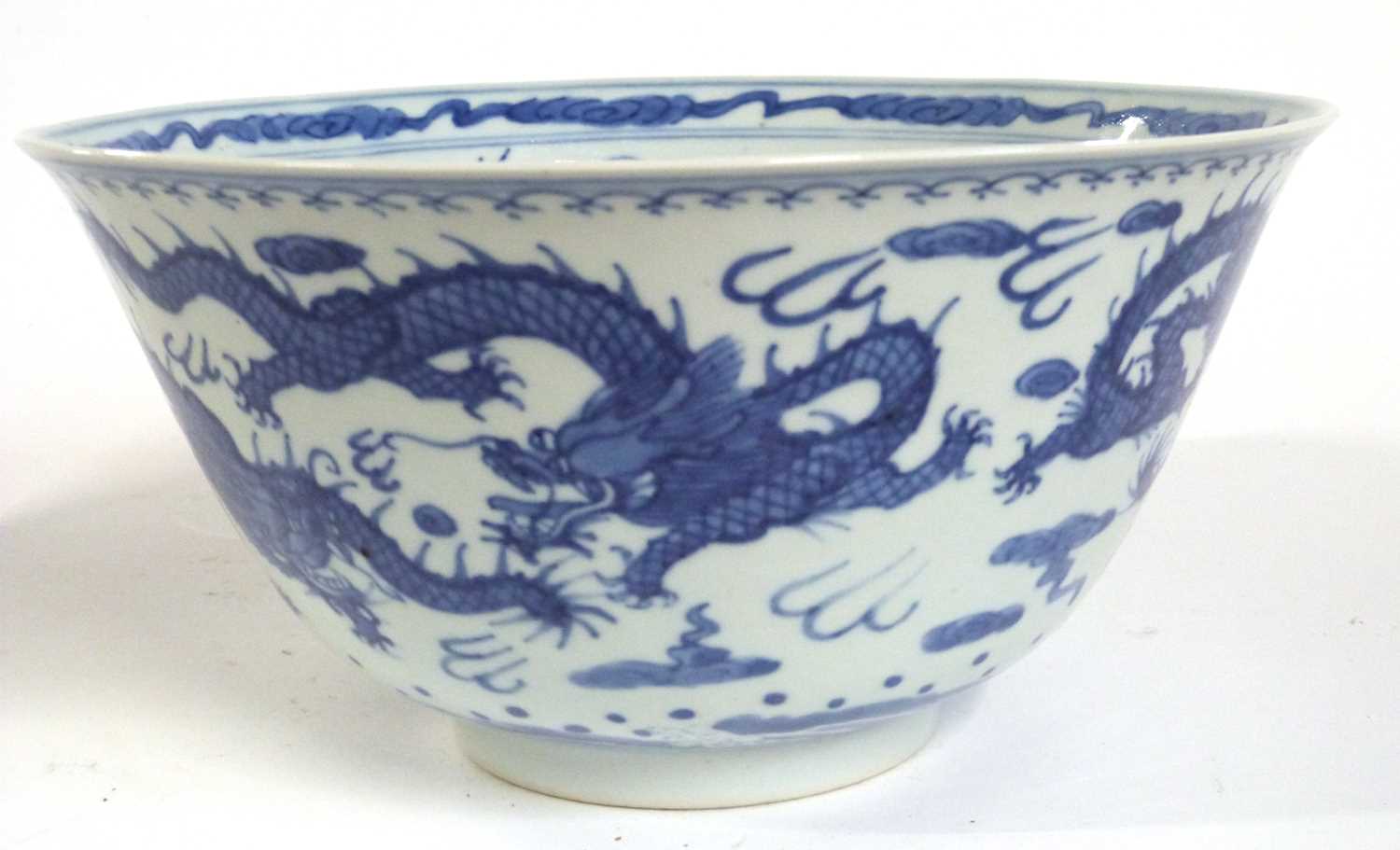 A Chinese porcelain bowl with everted rim, blue and white decorations of dragons chasing the flaming - Image 2 of 6
