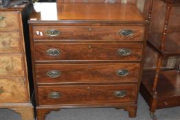 A late Georgian mahogany chest of drawers of small proportions with four graduated drawers set