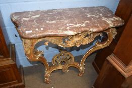 A marble topped gilt wood framed console table with scrolled and foliate decorated frame, 97cm wide